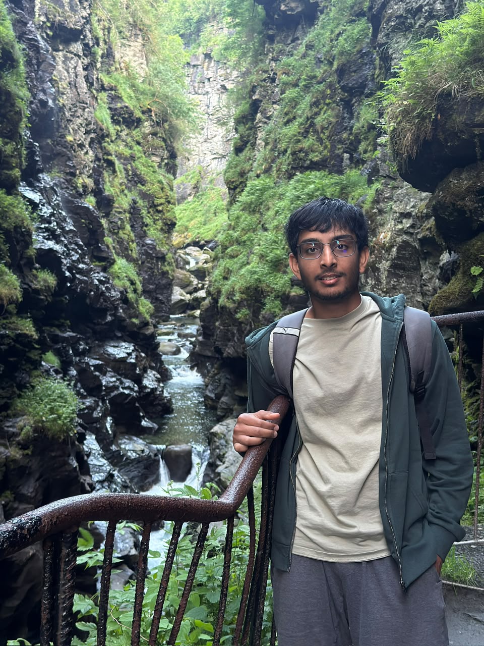 Portrait while hiking in a green rocky gorge